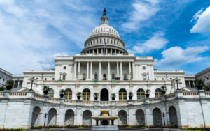 US Capitol building in front of a cloudy blue sky