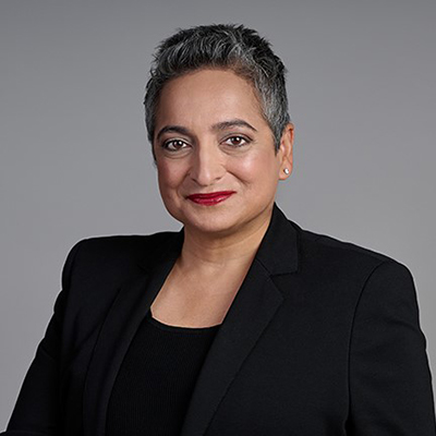 Woman with short dark hair and wearing a black blazer